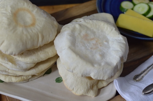 Pita bread is just the right size for a sandwich. Better than a bun, it doesn't get soggy when loaded down with tzatziki, hummus, or lamb and hot sauce. Pita bread is a must for gyros and schwarma. And it's pretty quick to make. You don't even need to wait for the bread to rise a second time before you bake it.
