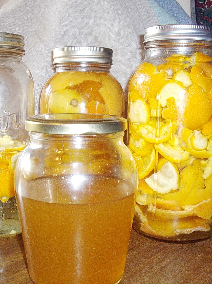 citrus cleaner in a jar and jars with citrus peels