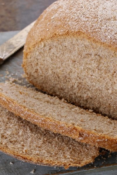 Fresh baked gluten free bread sliced on a cutting board