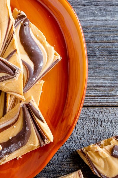 A peanut butter and chocolate bark on an orange plate