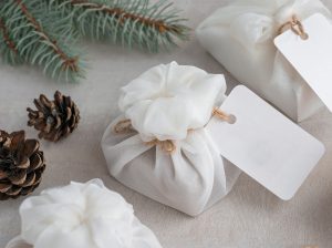 Christmas presents wrapped with white furoshiki fabric