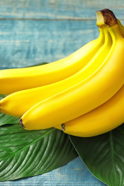 Fresh bananas sitting on banana leaves