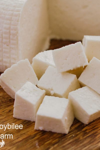 cubed white cheese on a wooden cutting board