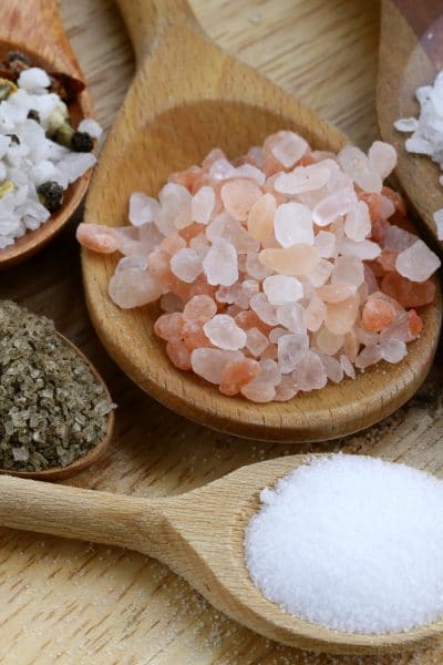 Different types of salts on wooden spoons