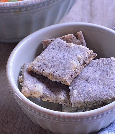 Cheesy low carb crackers are easy to make at home.  No need to pay the big bucks to get gluten-free crackers that taste like cardboard, when you can have these on the table in 40 minutes from start to finish.